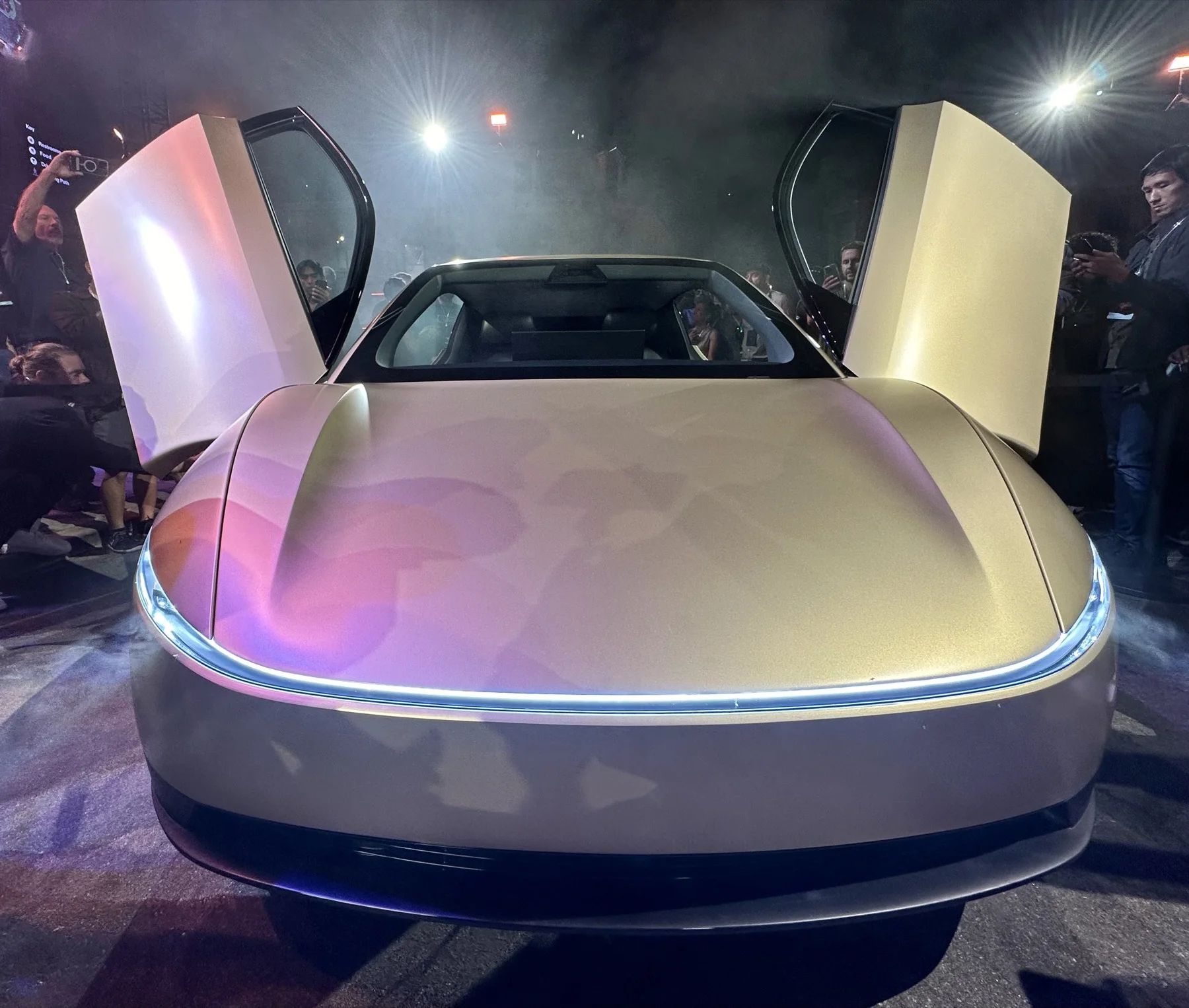Front view of the Tesla Cybercab concept with gullwing doors open.