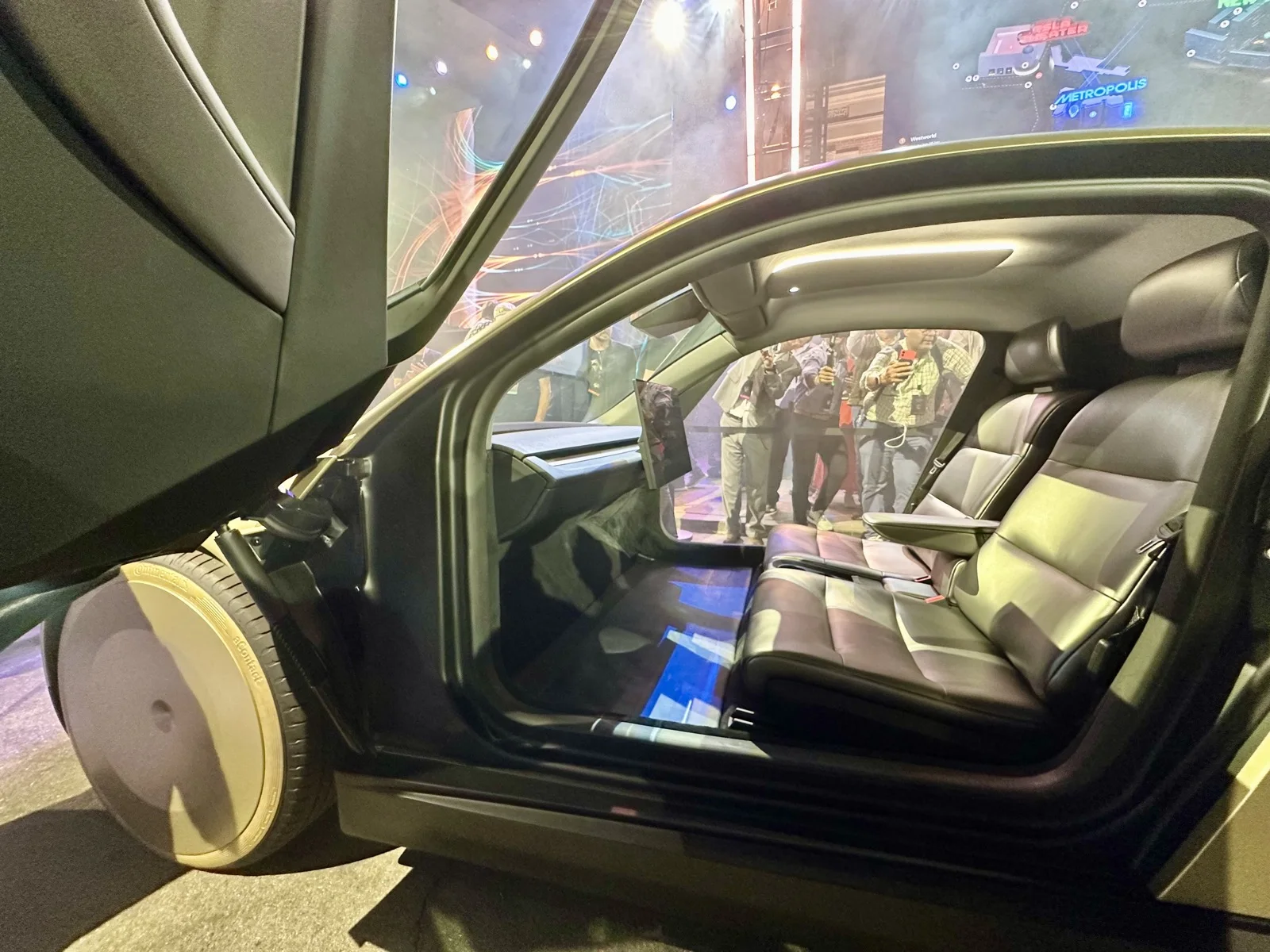 Inside the Tesla Cybercab showing the two-seat cabin and center display.